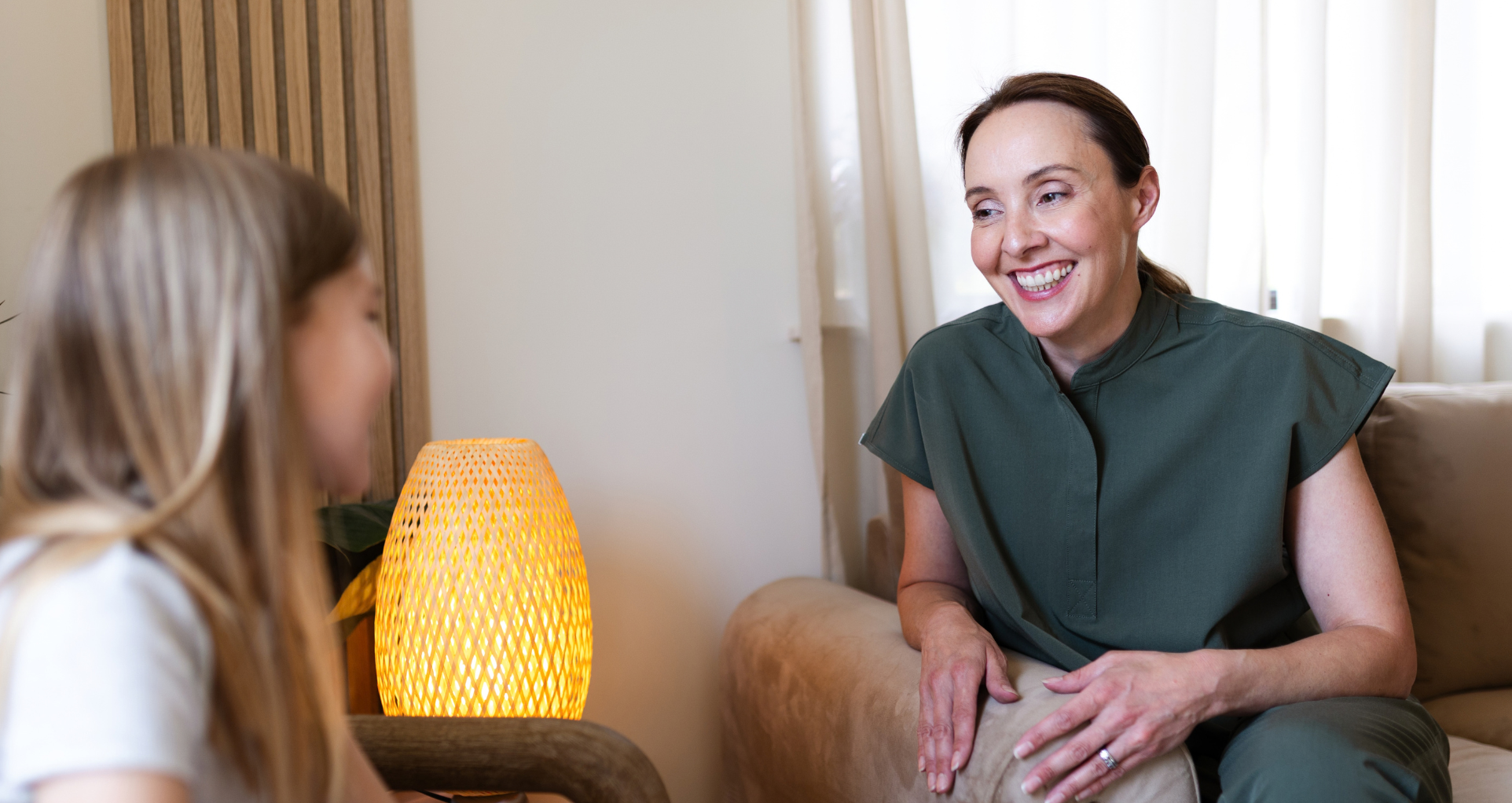 Everwell Dental team member chatting with a patient in the relaxed patient lounge